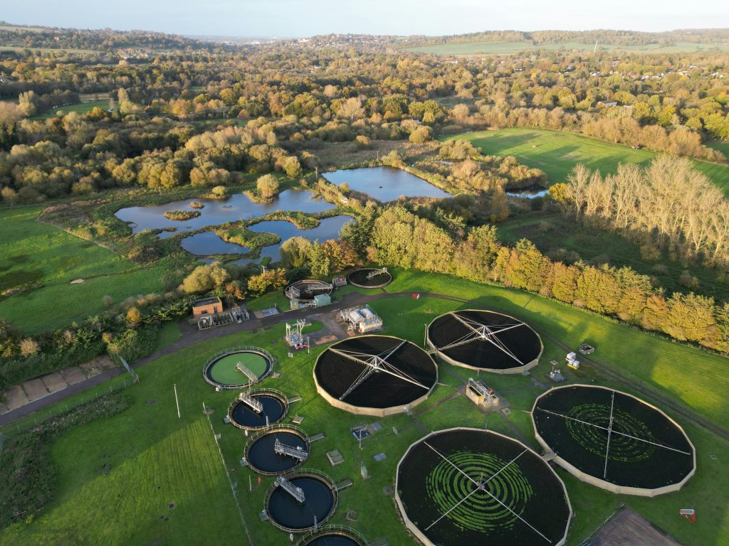 Drone shot of a picturesque rural water treatment plant surrounded by nature.